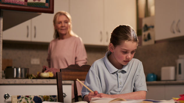 Ruby sitting in home kitchen doing homework