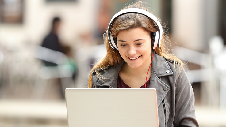 Girl using laptop outside