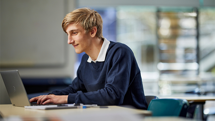 a high school student on his laptop