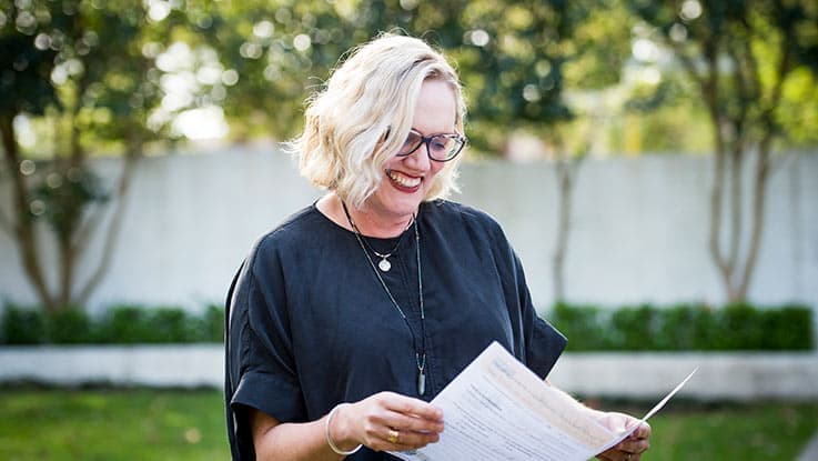 Woman standing in garden and looking at comms