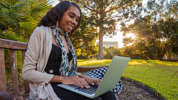 young woman on a laptop in the park