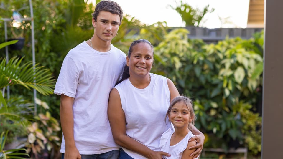 family wearing white shirts smiling