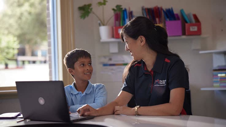 a student smiling at their teacher