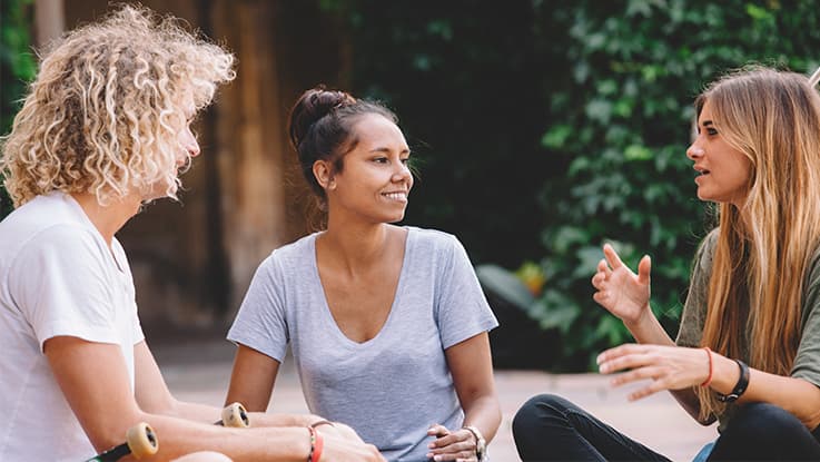 Girls sitting talking at campus