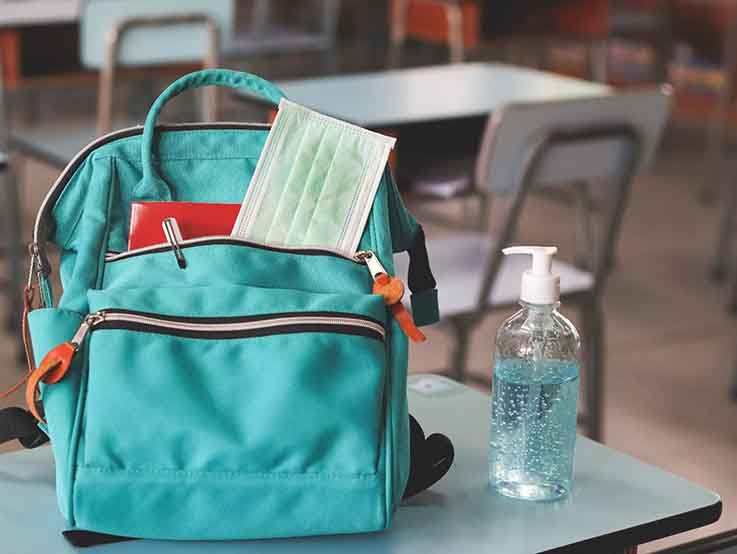 Backpack and santizer on desk