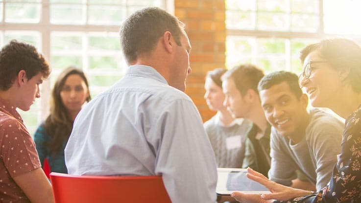 A group of people seating together and brainstorming 